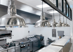 Modern kitchen with stainless steel appliances and pendant lights