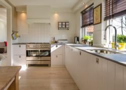 Modern kitchen with stainless steel appliances and wooden flooring