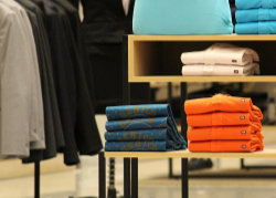 Clothing display with folded clothes on shelves in a store setting